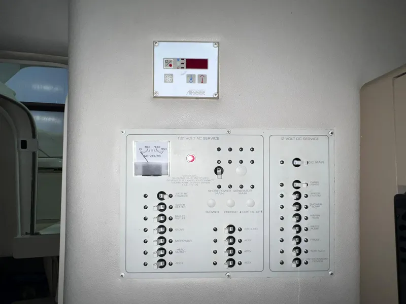 Slide: The Image of Control panel of a 2001 Larson 270 boat with various switches and gauges. - 24