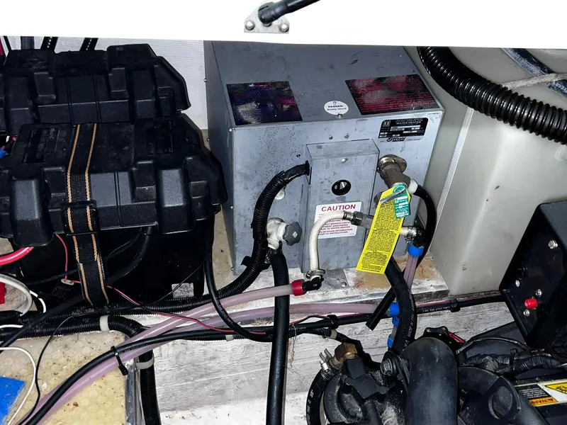 Slide: The Image of 2001 Larson 270 boat engine compartment with battery and electrical components. - 28