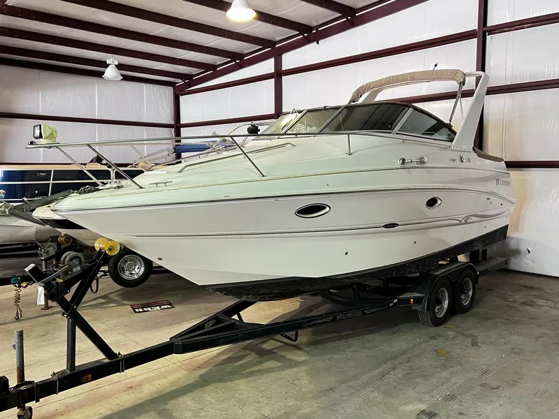 Slide: The Image of 2001 Larson 270 boat on trailer in indoor storage facility. - 3