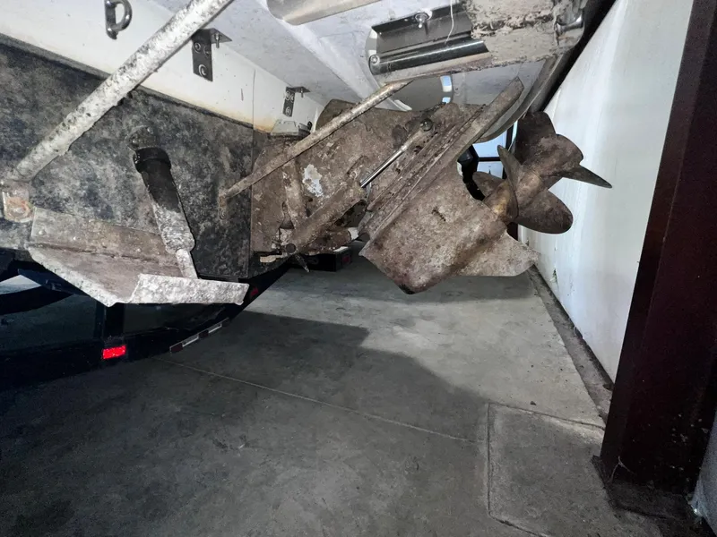 Slide: The Image of 2001 Larson 270 boat propeller and stern drive in a garage. - 30