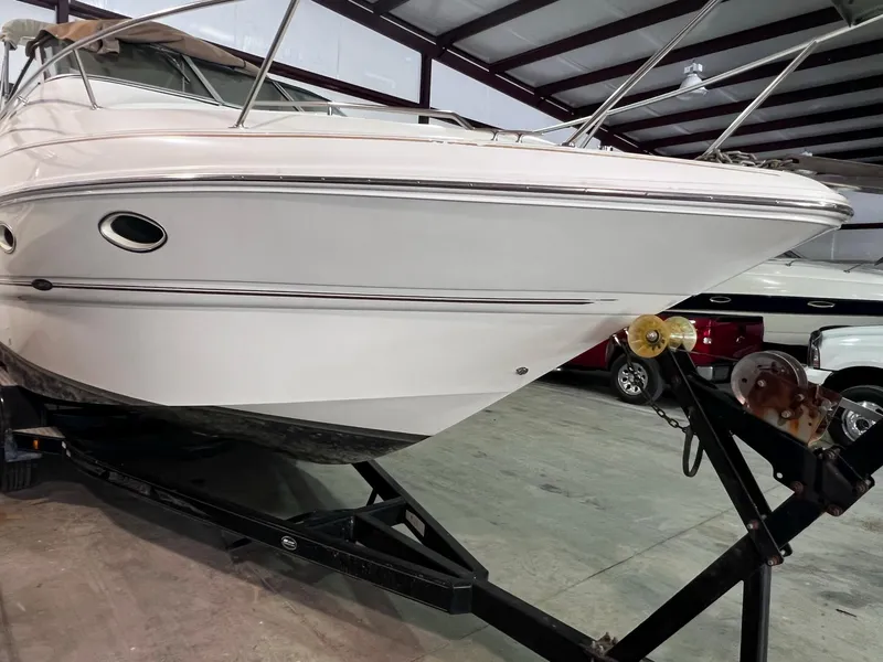 Slide: The Image of 2001 Larson 270 boat on trailer in indoor storage facility. - 32