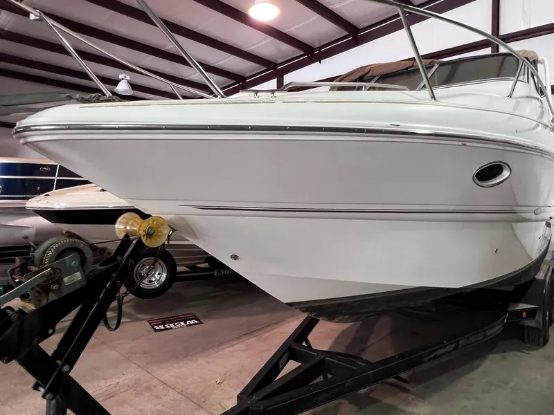 Slide: The Image of 2001 Larson 270 boat on trailer in indoor storage facility. - 33