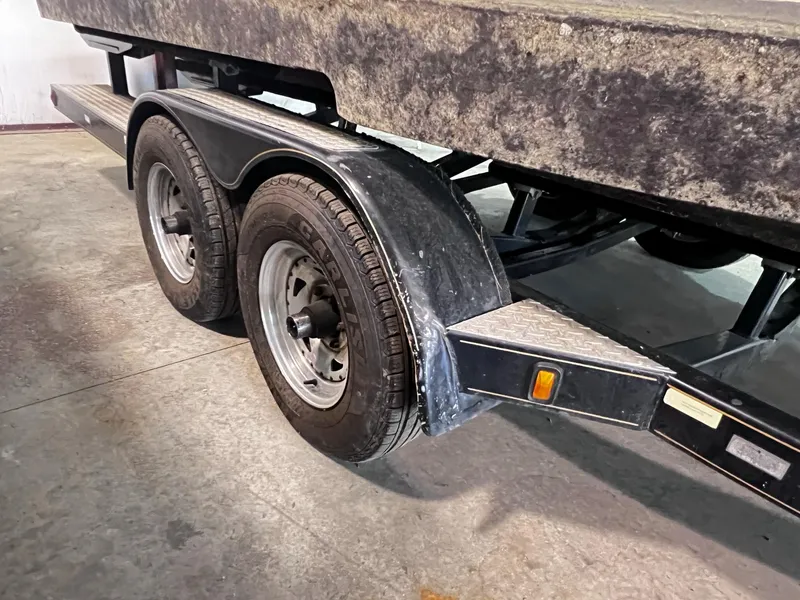 Slide: The Image of 2001 Larson 270 boat trailer with dual axles in a garage. - 36