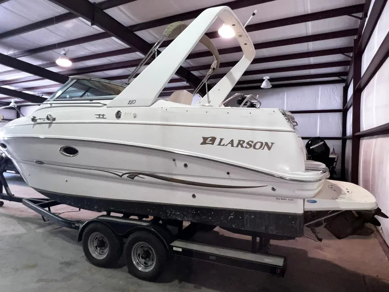 Slide: The Image of 2001 Larson 270 boat on a trailer in a storage facility. - 5