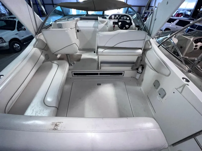 Slide: The Image of 2001 Larson 270 boat interior with white seating and steering console. - 6