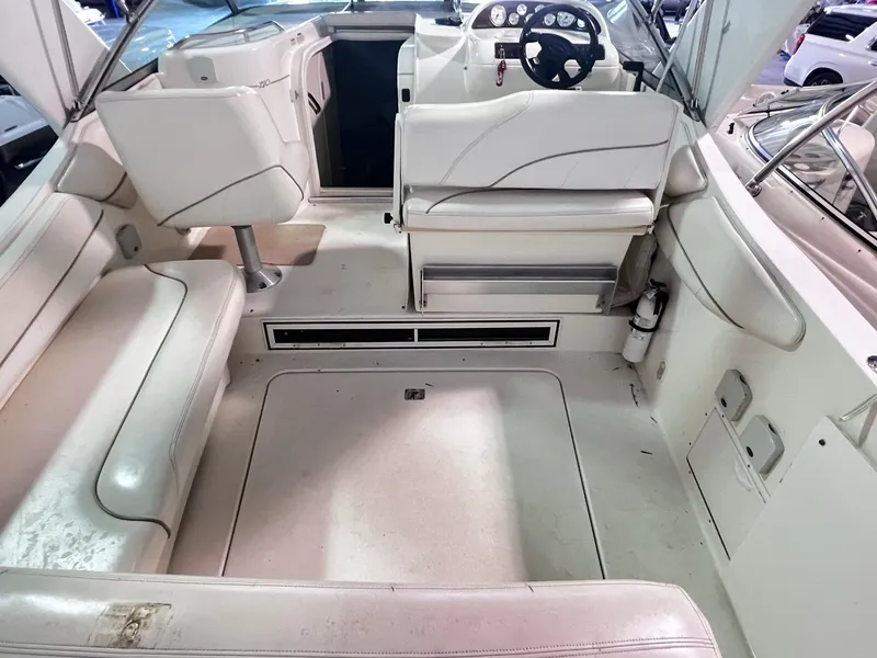 Slide: The Image of 2001 Larson 270 boat interior with white seating and steering console. - 8