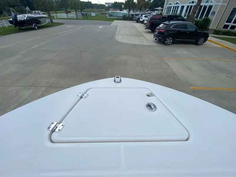 Slide: The Image of 2024 Robalo 202 EXPLORER boat bow view in a parking lot. - 19