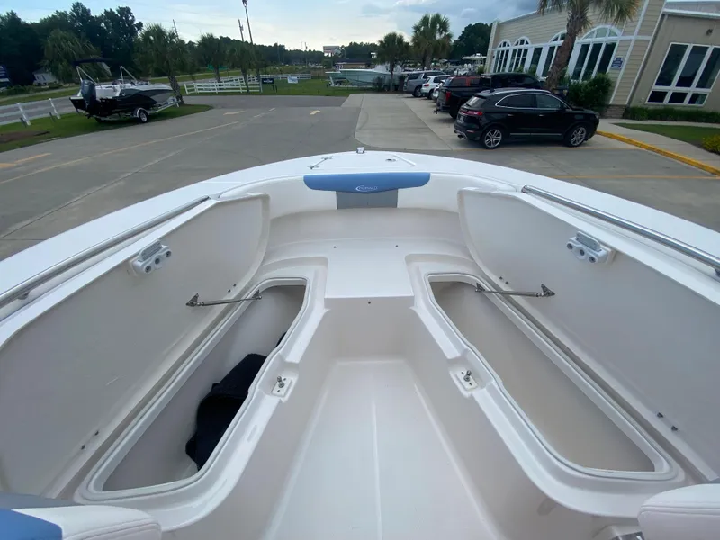 Slide: The Image of 2024 Robalo 202 EXPLORER boat with open storage compartments. - 21