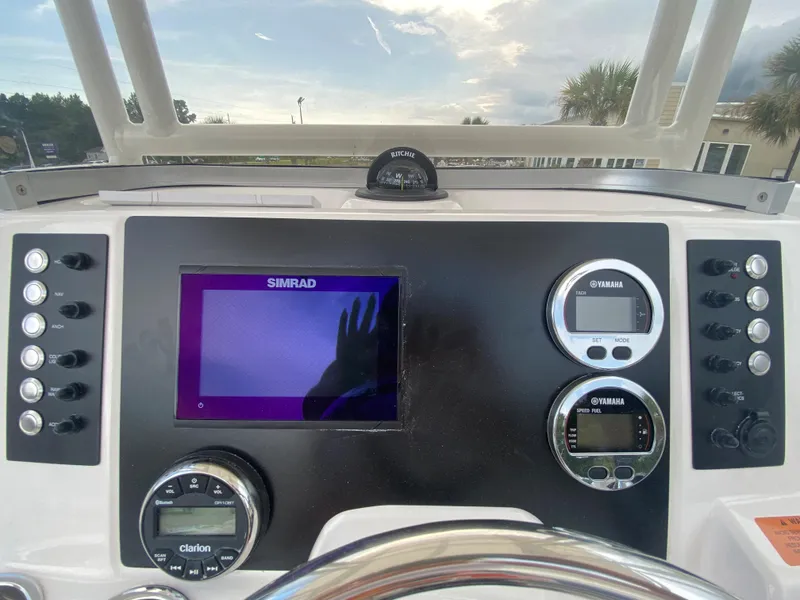 Slide: The Image of 2024 Robalo 202 EXPLORER boat dashboard with Simrad display and Yamaha gauges. - 12