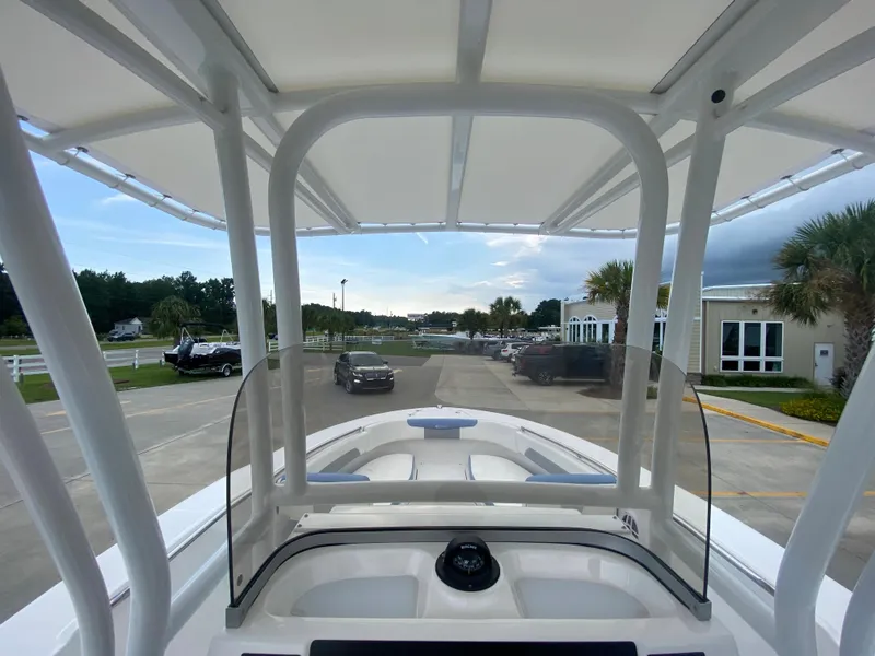 Slide: The Image of 2024 Robalo 202 EXPLORER boat interior view with T-top and windshield. - 13