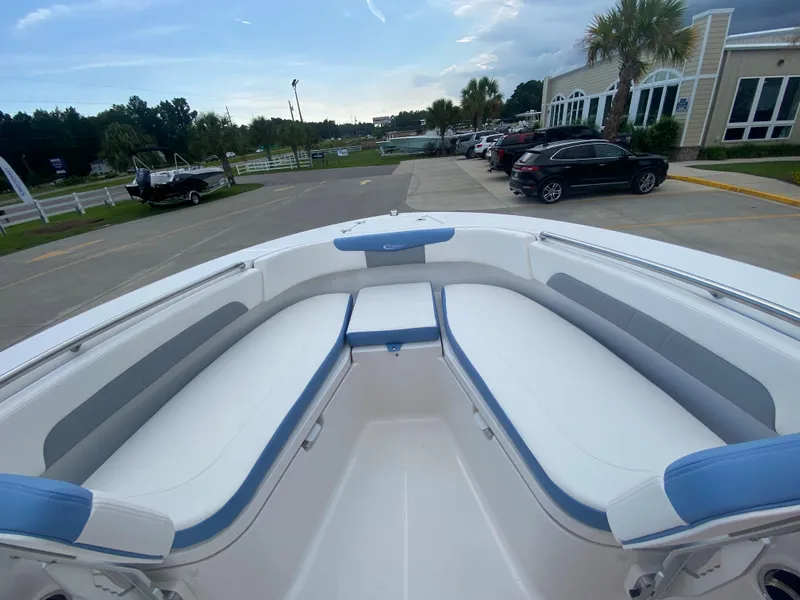 Slide: The Image of 2024 Robalo 202 EXPLORER boat interior with white and blue seating. - 17