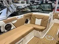 Slide: The Image of 2024 MasterCraft XT22 T boat interior with tan and white seating. - 10