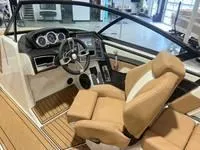 Slide: The Image of 2024 MasterCraft XT22 T boat interior with tan seats and modern dashboard. - 11