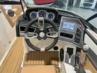 Slide: The Image of 2024 MasterCraft XT22 T boat dashboard with steering wheel and control panel. - 12