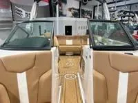 Slide: The Image of 2024 MasterCraft XT22 T interior with tan and white seating, open bow design. - 13