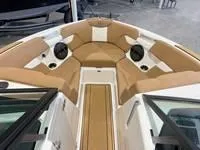 Slide: The Image of 2024 MasterCraft XT22 T boat interior with tan seating and speakers. - 14