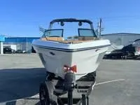 Slide: The Image of 2024 MasterCraft XT22 T boat on a trailer in a parking lot. - 3