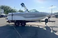 Slide: The Image of 2024 MasterCraft XT22 T boat on a trailer in a parking lot. - 6
