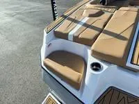 Slide: The Image of 2024 MasterCraft XT22 T boat with tan seating and cup holder. - 8