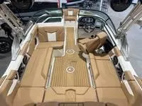 Slide: The Image of 2024 MasterCraft XT22 T boat interior with tan seating and modern dashboard. - 9