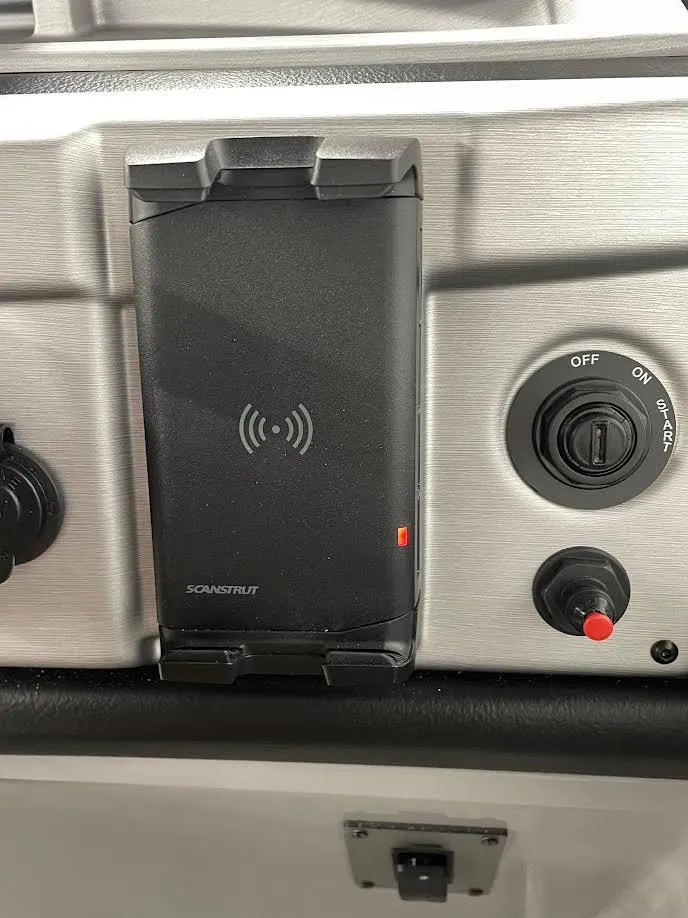 Slide: The Image of Control panel of a 2023 Berkshire 22RFX CTS boat with wireless charging pad. - 14