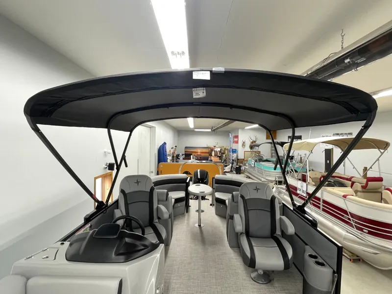 Slide: The Image of 2023 Berkshire 22RFX CTS pontoon boat interior with canopy in showroom. - 2