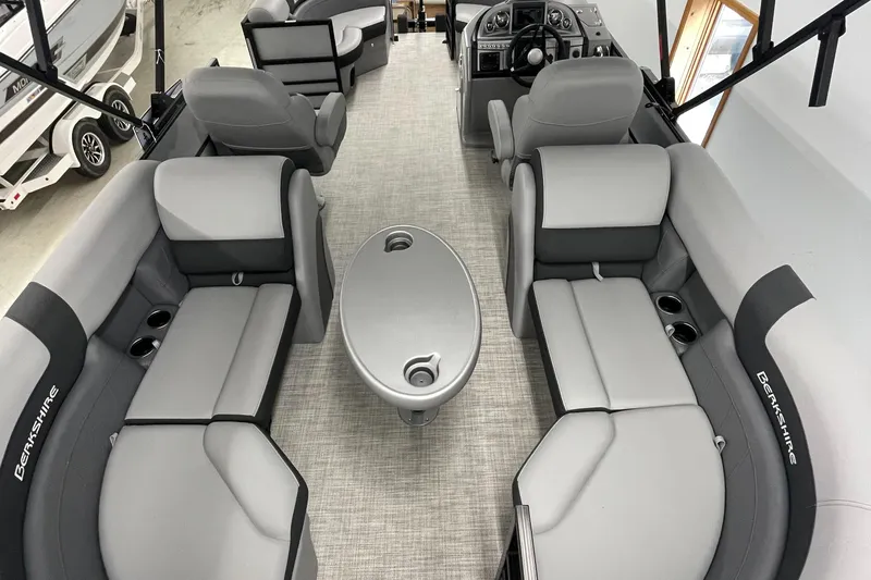 Slide: The Image of 2023 Berkshire 22RFX CTS pontoon boat interior with gray seating and central table. - 4
