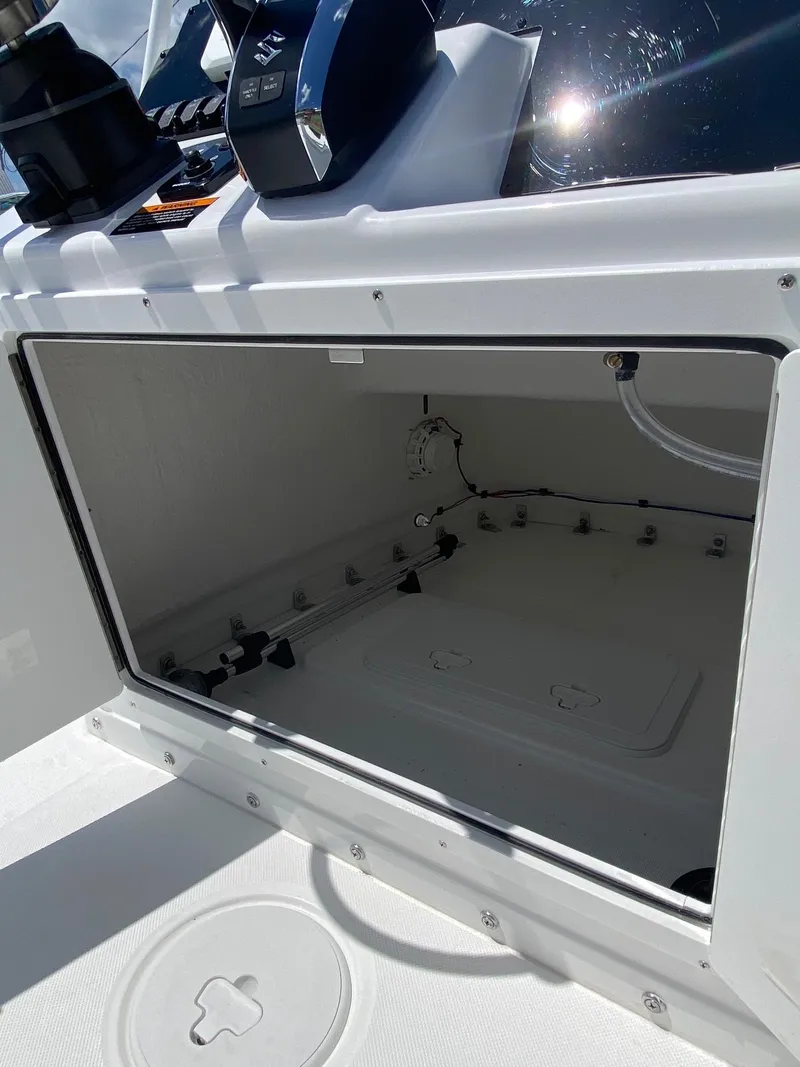 Slide: The Image of 2024 Savannah 220 IS boat storage compartment with open hatch. - 11