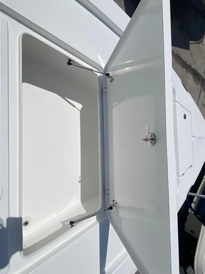 Slide: The Image of 2024 Savannah 220 IS boat storage compartment open. - 15