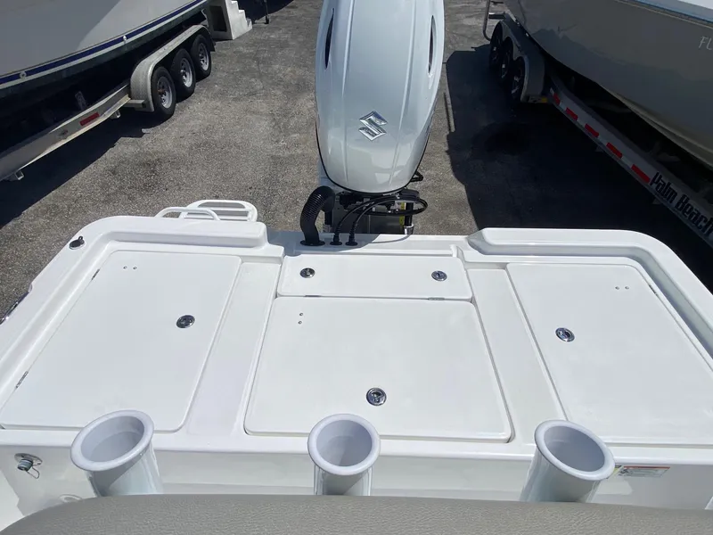 Slide: The Image of 2024 Savannah 220 IS boat stern with Suzuki outboard motor and rod holders. - 16