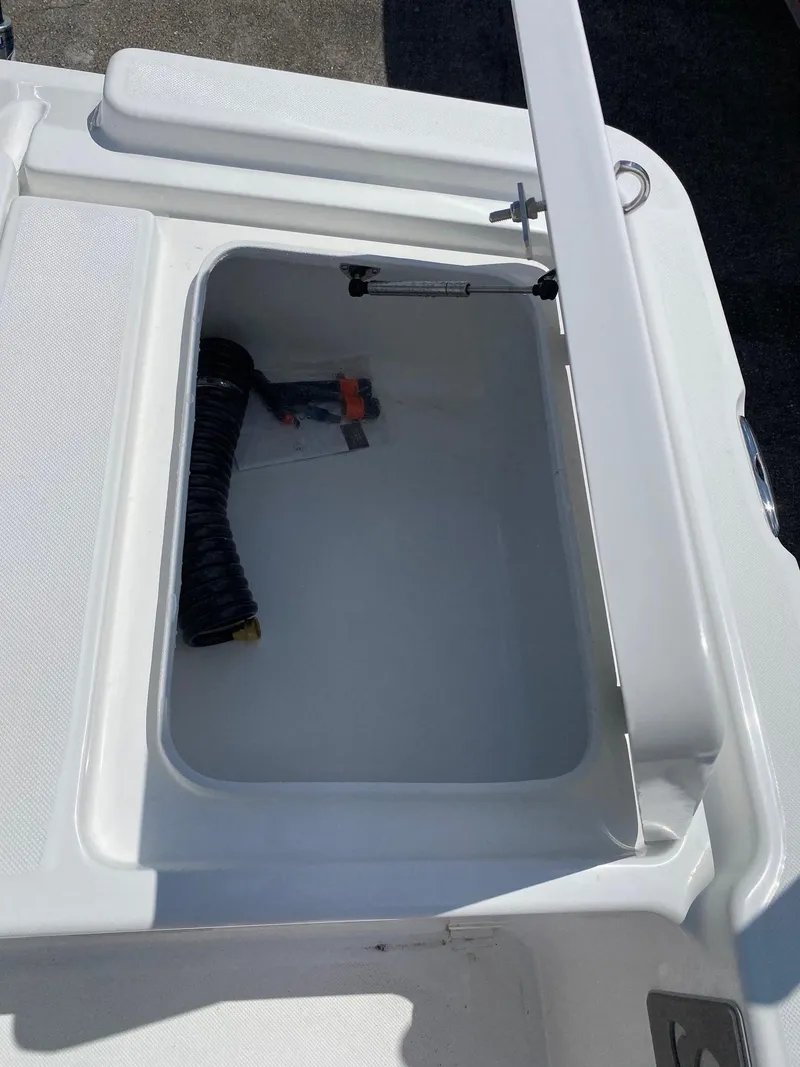 Slide: The Image of Storage compartment of 2024 Savannah 220 IS boat with open lid. - 19