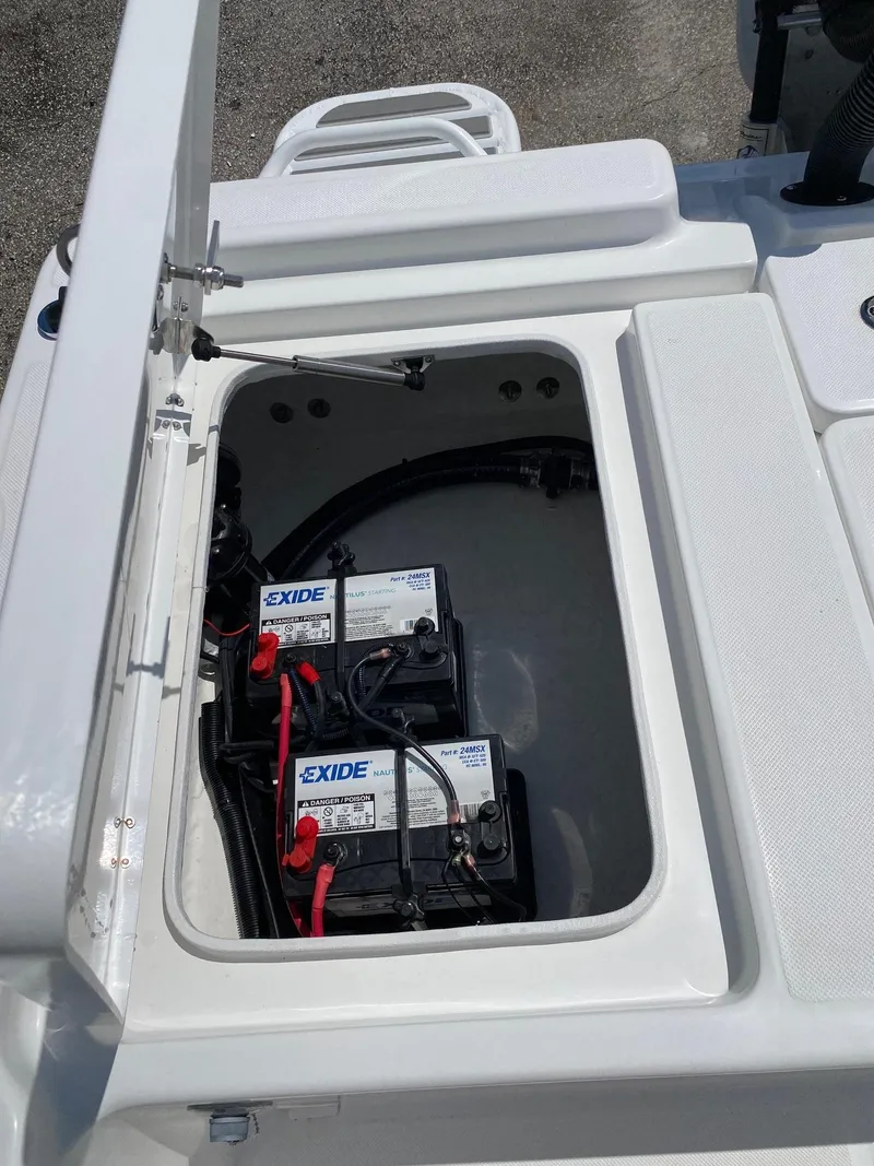 Slide: The Image of 2024 Savannah 220 IS boat battery compartment with Exide batteries. - 20