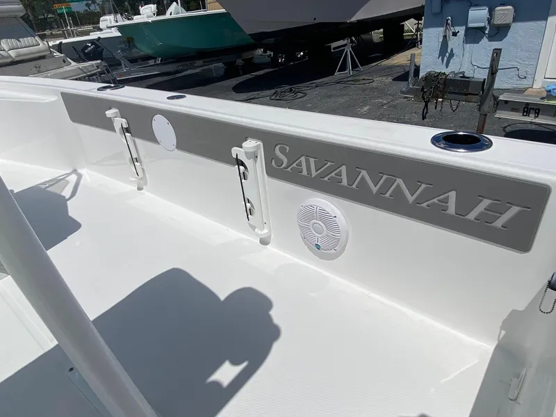 Slide: The Image of 2024 Savannah 220 IS boat interior with rod holders and speaker. - 22