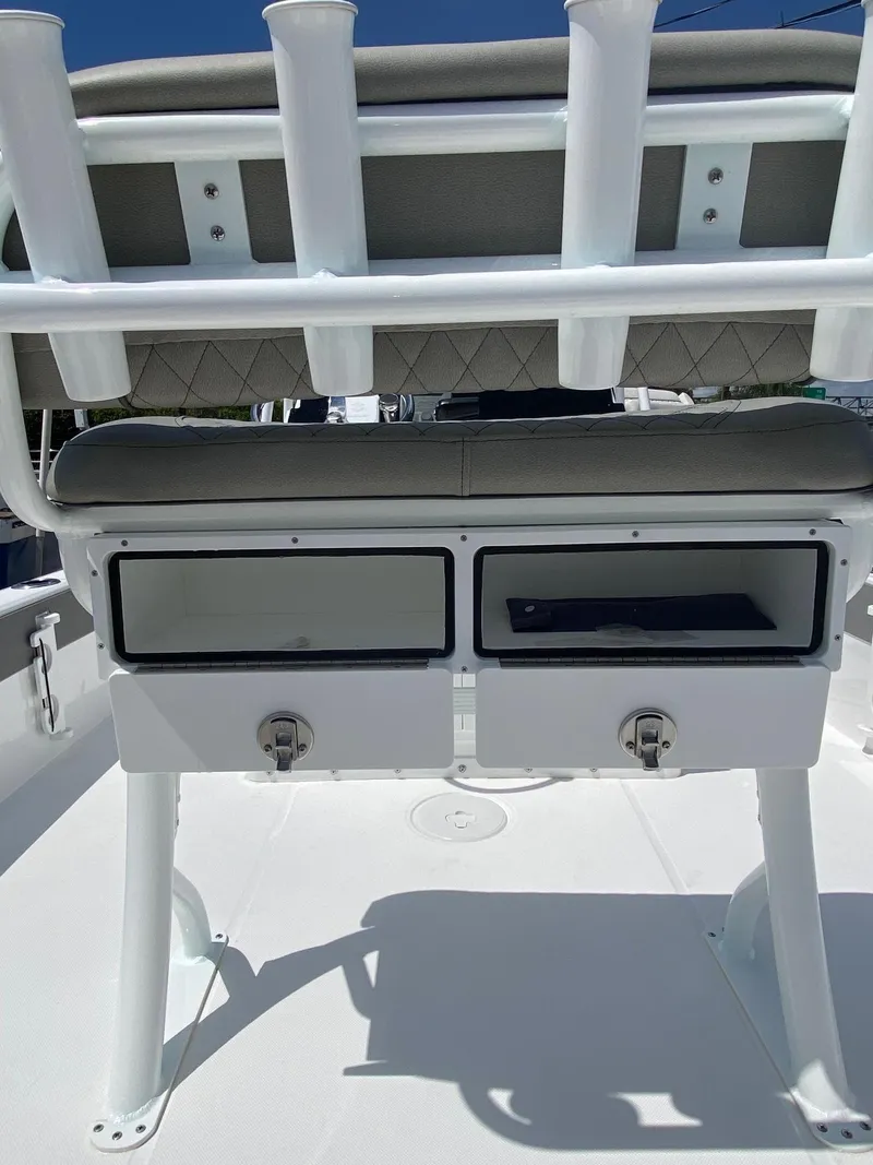 Slide: The Image of 2024 Savannah 220 IS boat with dual storage compartments and rod holders. - 24