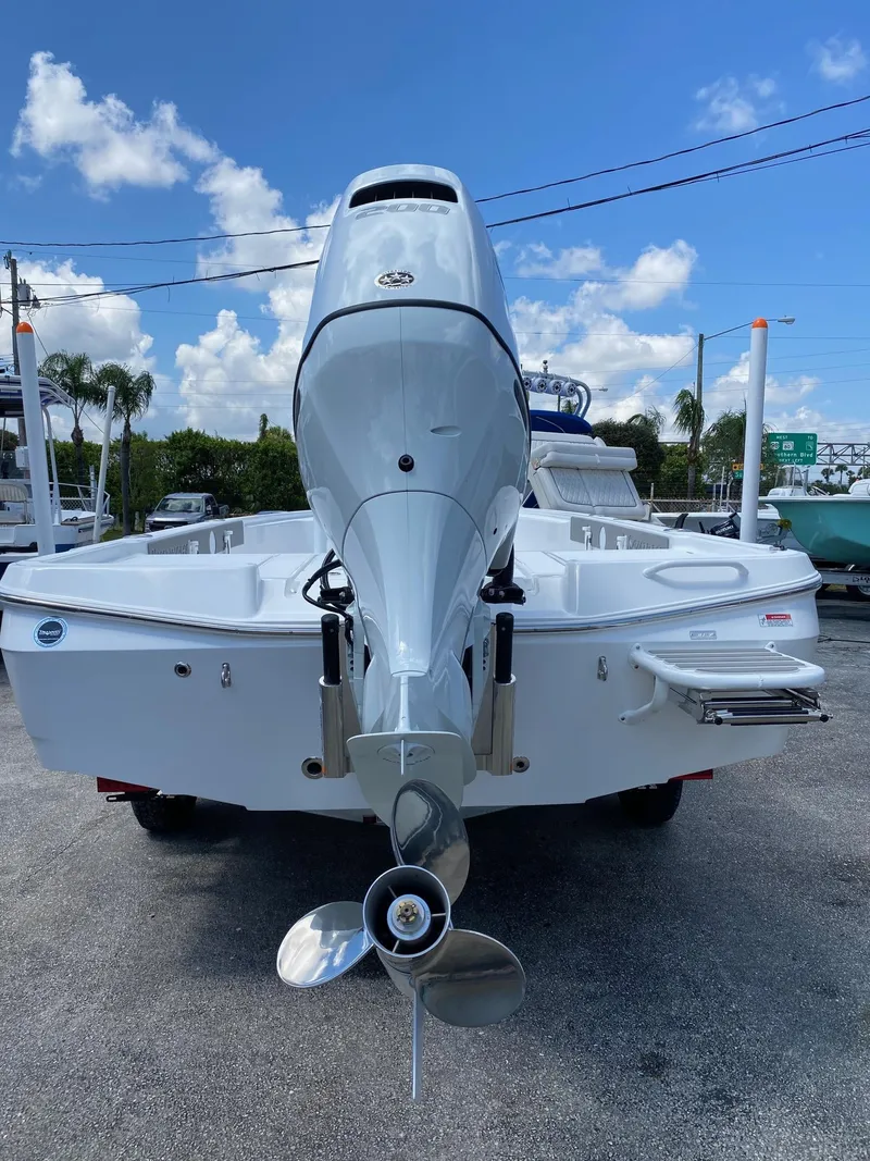 Slide: The Image of 2024 Savannah 220 IS boat rear view with outboard motor. - 26