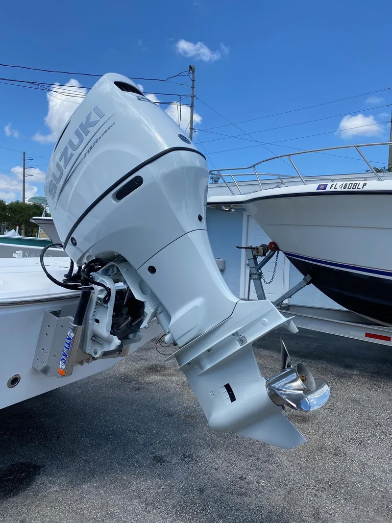 Slide: The Image of 2024 Savannah 220 IS boat with Suzuki outboard motor. - 27