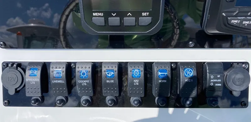 Slide: The Image of Control panel of a 2024 Savannah 220 IS boat with various switches and buttons. - 28