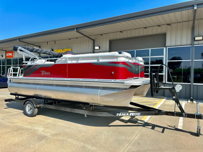 Slide: The Image of 2023 Tahoe Pontoon 19FT STX Cruise boat on a trailer outside a building. - 3