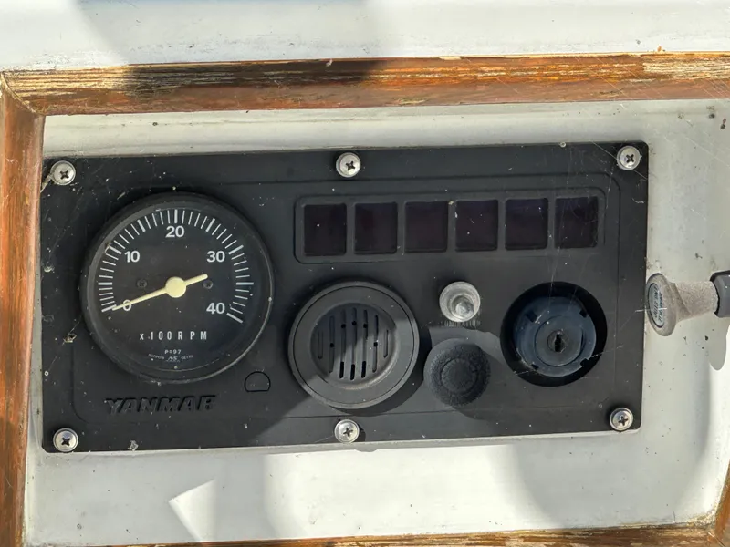 Slide: The Image of 1986 J Boats J30 Yanmar engine control panel with RPM gauge. - 15