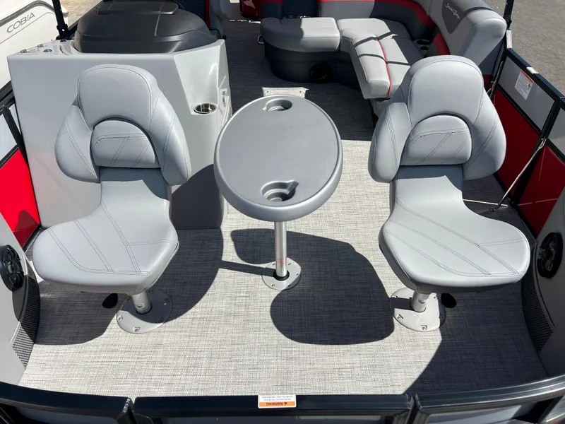 Slide: The Image of 2023 South Bay 22F 200 Series boat interior with two seats and a table. - 12