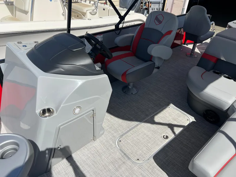 Slide: The Image of 2023 South Bay 22F 200 Series boat interior with helm, seating, and carpeted floor. - 18