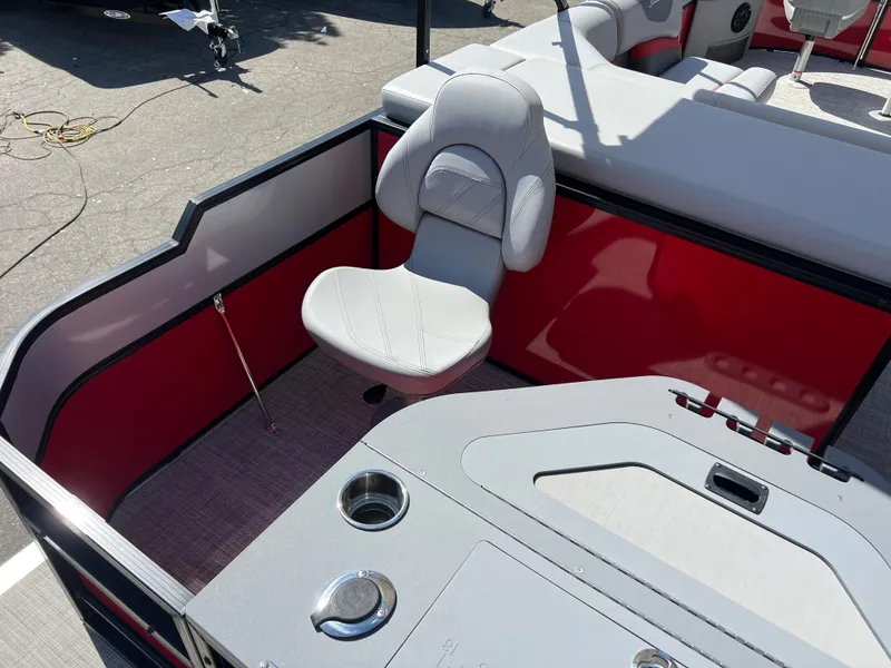 Slide: The Image of 2023 South Bay 22F 200 Series boat interior with red and gray seating. - 23