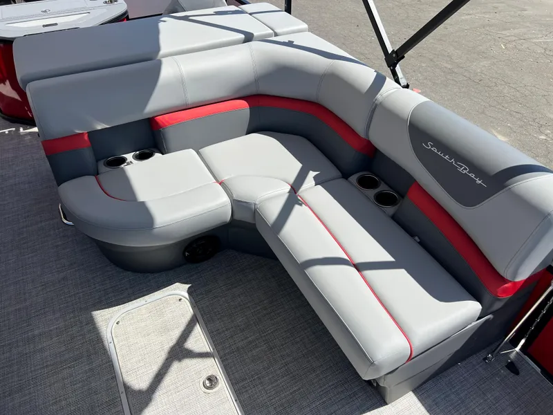 Slide: The Image of 2023 South Bay 22F 200 Series boat interior with gray and red seating. - 24