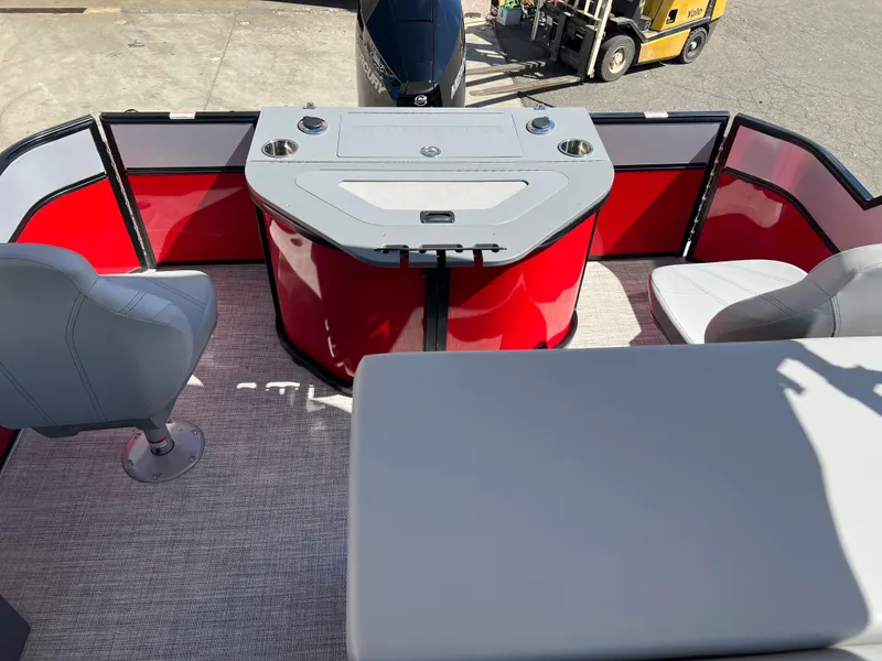 Slide: The Image of 2023 South Bay 22F 200 Series pontoon boat interior with red and gray seating. - 25
