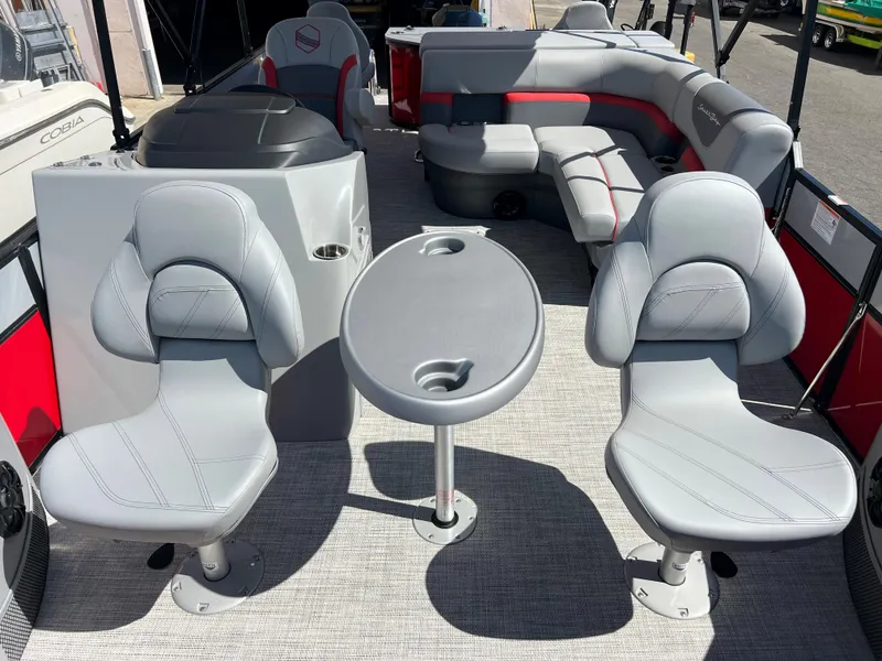 Slide: The Image of 2023 South Bay 22F 200 Series pontoon boat interior with seating and table. - 6