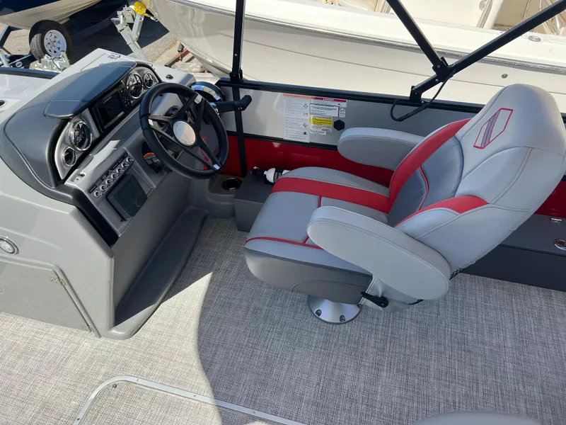 Slide: The Image of 2023 South Bay 22F 200 Series boat interior with captain's chair and control panel. - 7