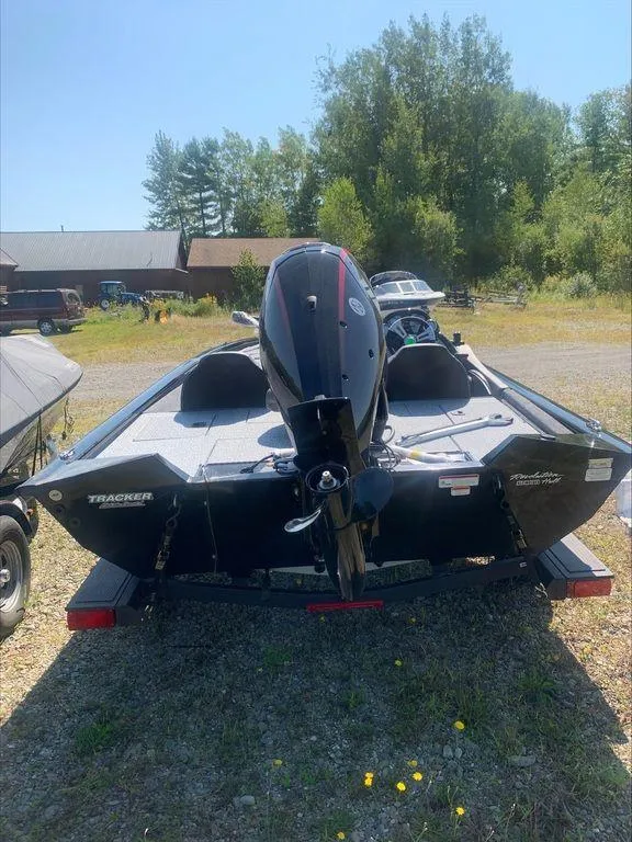 Slide: The Image of 2024 Tracker PT 195 XTE boat, rear view, parked outdoors. - 8