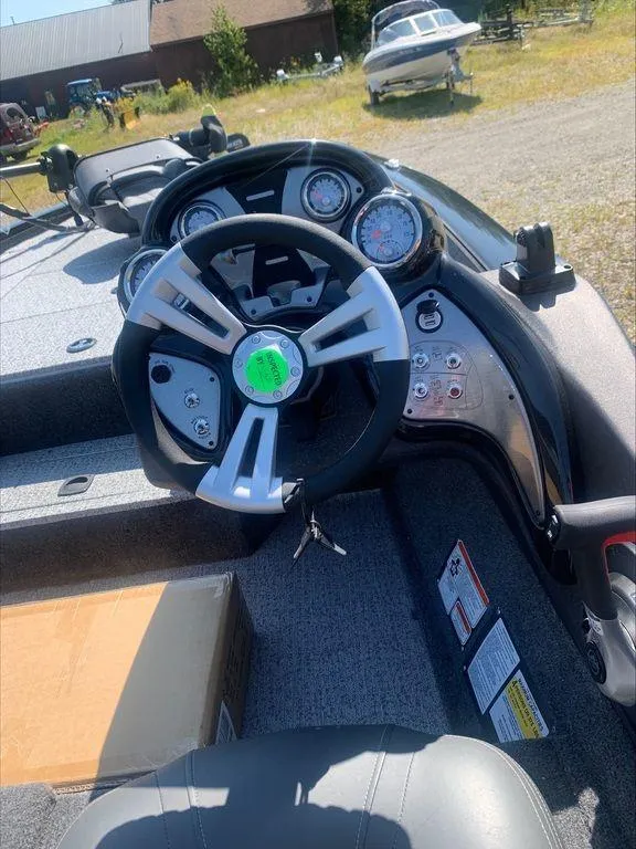 Slide: The Image of 2024 Tracker PT 195 XTE boat dashboard and steering wheel. - 9