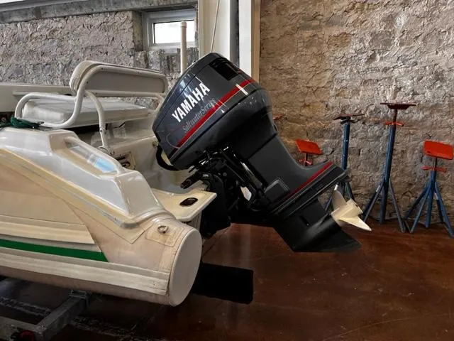 Slide: The Image of 1998 Nautica RIB 18 Widebody with Yamaha outboard motor in a garage. - 4
