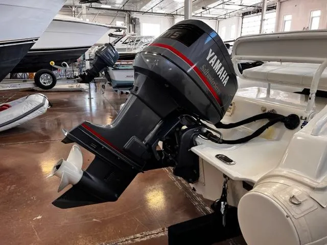 Slide: The Image of 1998 Nautica RIB 18 Widebody with Yamaha outboard motor in a boat showroom. - 5